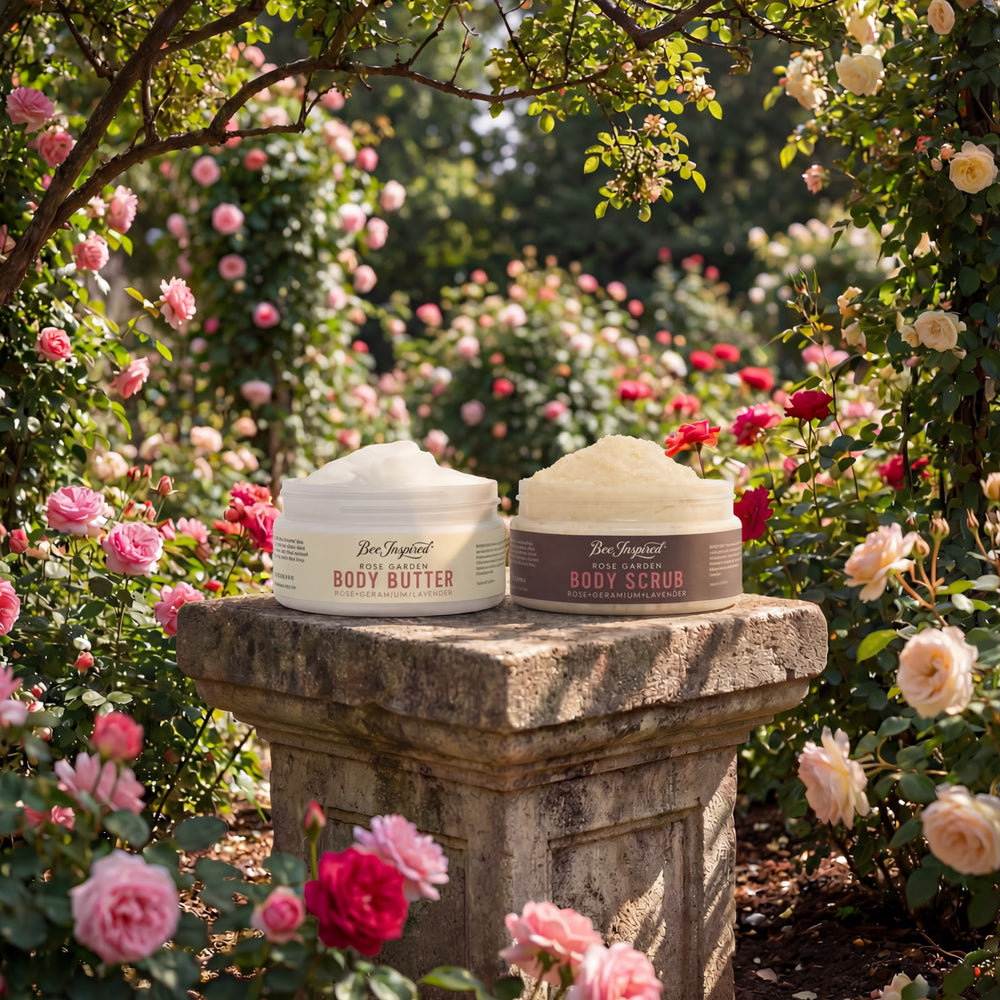 Two jars of body products on a stone pedestal with a garden of flowers in the background