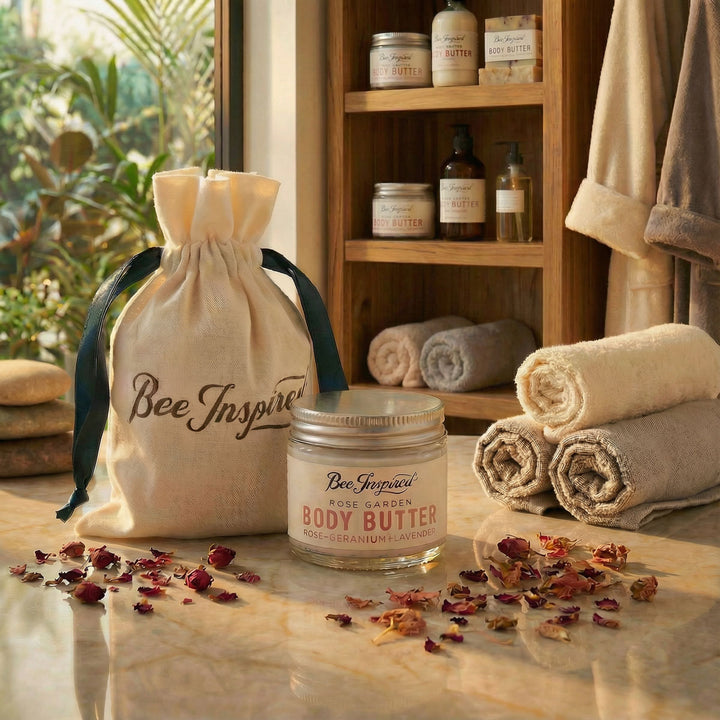 Bee Inspired body butter party favor jar with a drawstring bag and towels in a spa setting