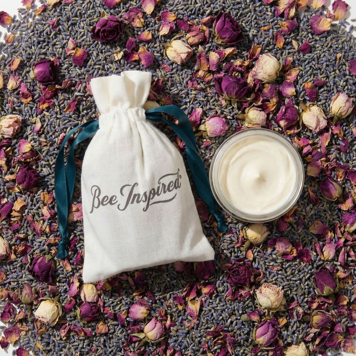 party favor jar and 'Bee Inspired' pouch on a bed of lavender and rose petals