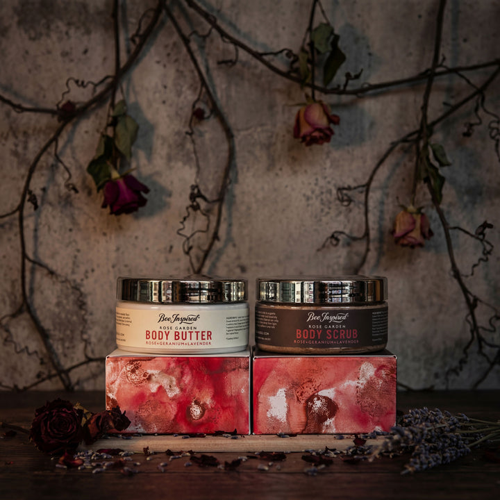 Two jars of body products on decorative boxes with a rustic background