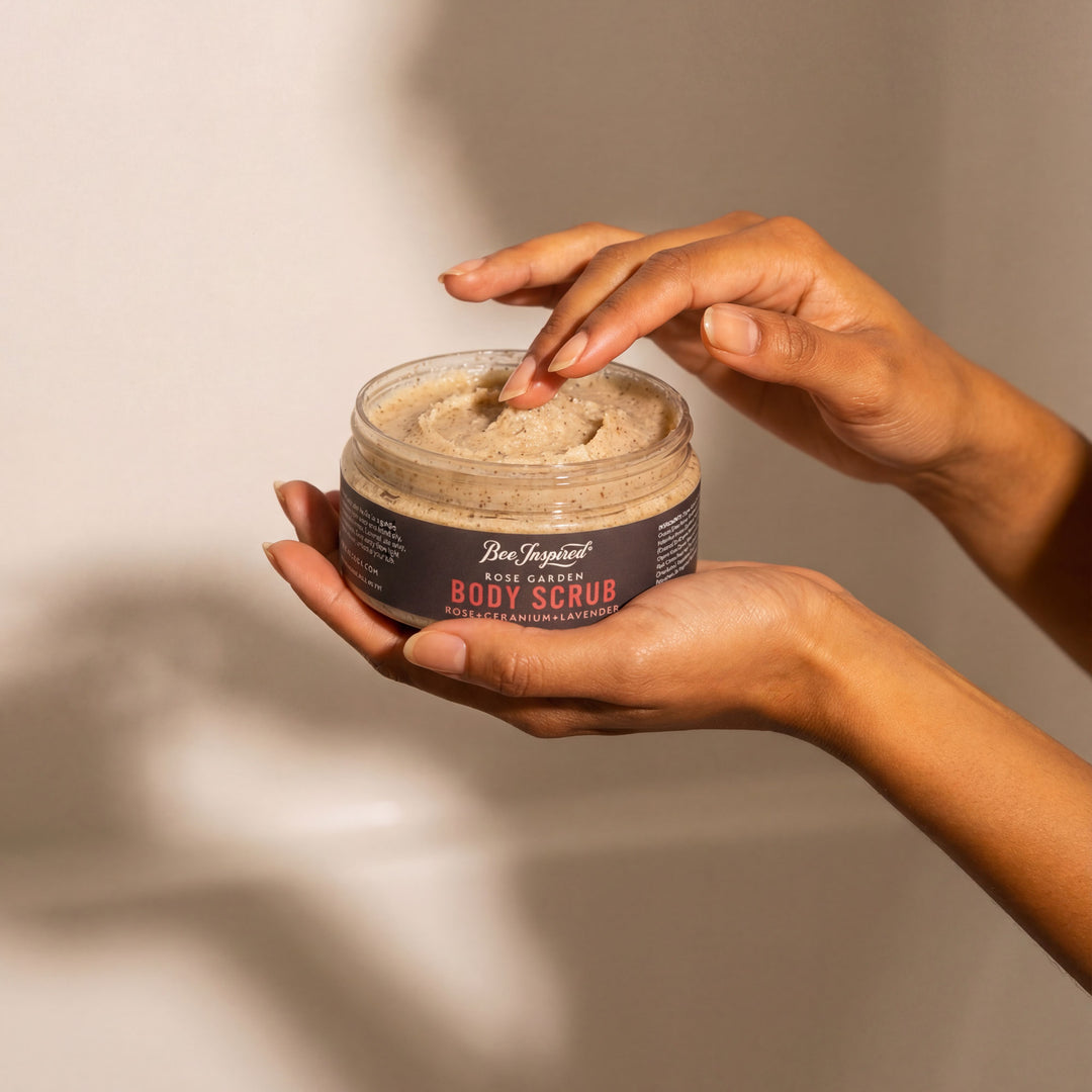Person holding a jar of body scrub with a neutral background