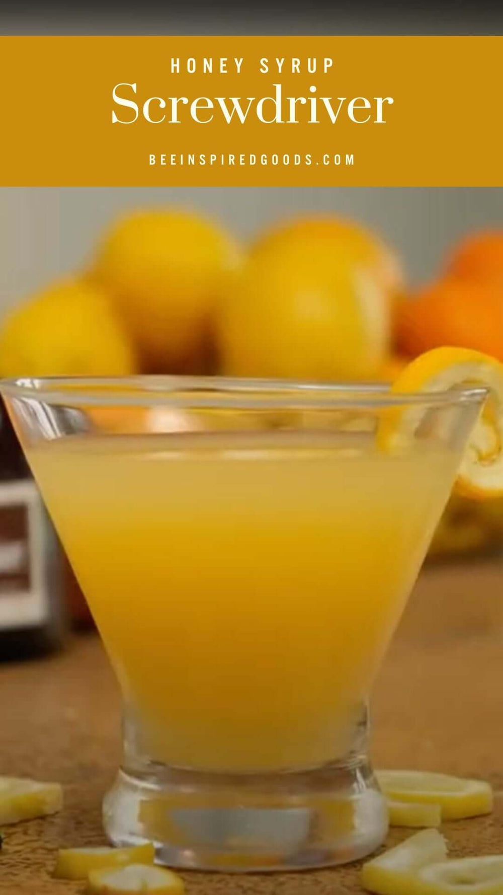 Honey Syrup screwdriver in front of oranges 