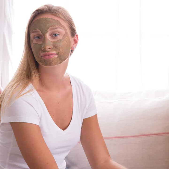 woman wearing bee inspired sea + tea dry mask on her face