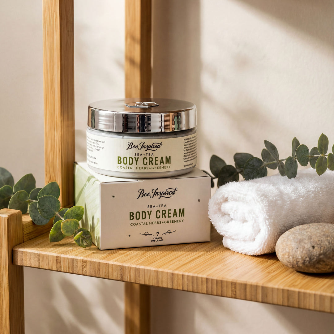 Body cream jar and packaging on a wooden shelf with eucalyptus leaves and a towel.