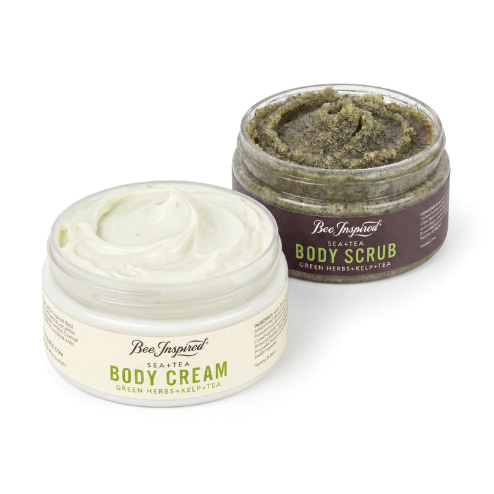 Two jars of 'Bee Inspired' body cream and scrub on a white background
