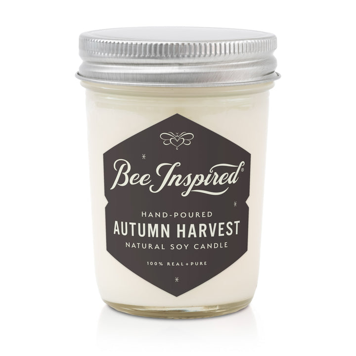 Bee Inspired Autumn Harvest candle in a glass jar with a metal lid on a white background