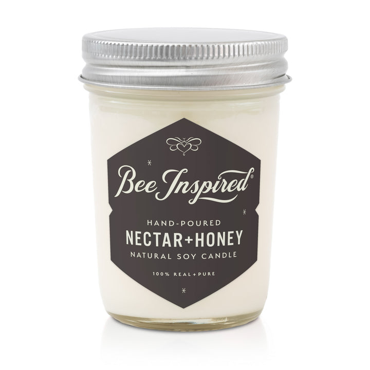 Candle jar labeled 'Bee Inspired Nectar + Honey' on a white background
