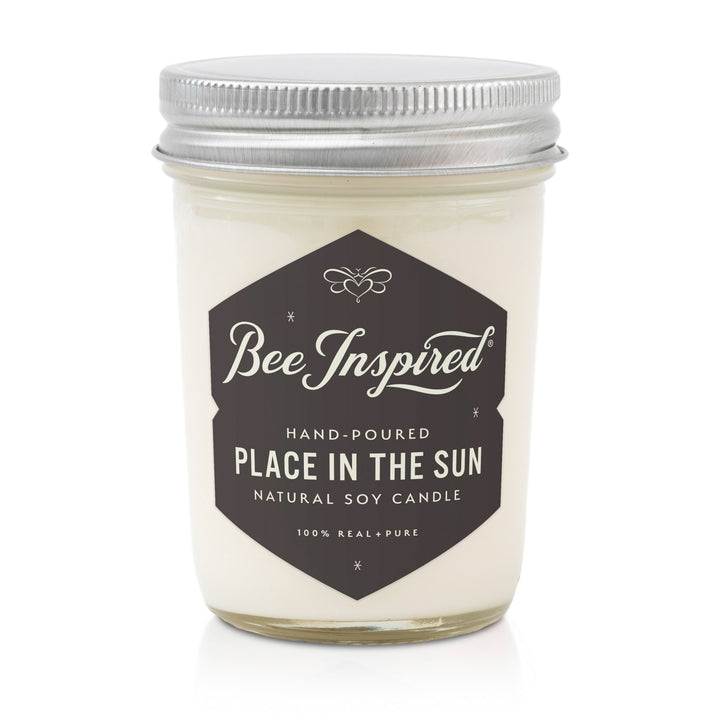 Candle jar with 'Bee Inspired' label on a white background