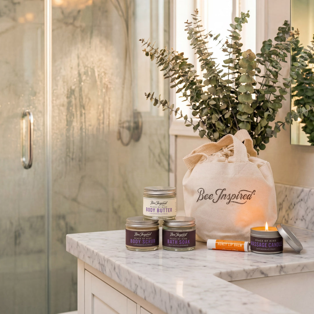 Bathroom counter with 'Bee Inspired' products including candles and a bag.