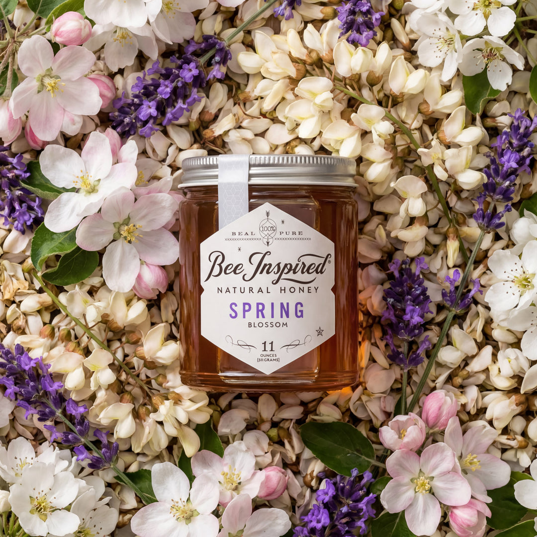 Jar of 'Bee Inspired' natural honey surrounded by spring flowers