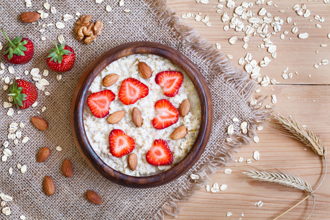 Bowl of oatmeal topped with strawberries and almonds 