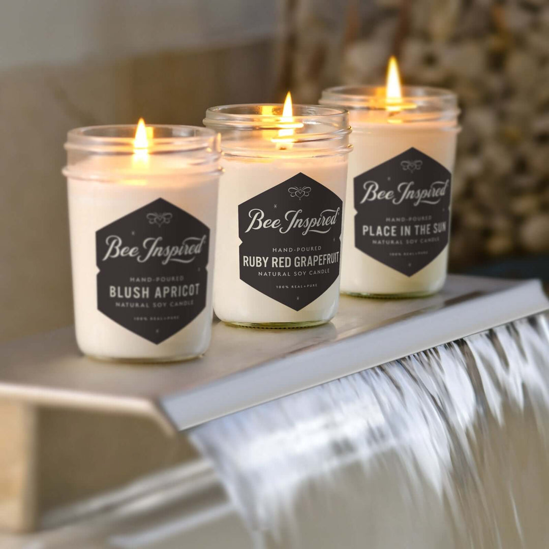 Summer Candle Set burning on the faucet of a bath tub