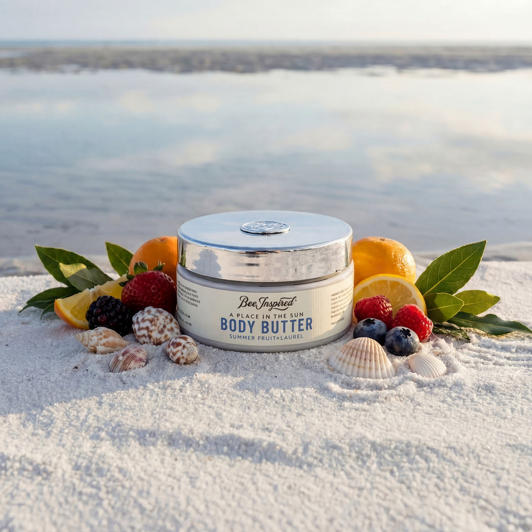 Body butter jar with fruits and leaves on a sandy beach