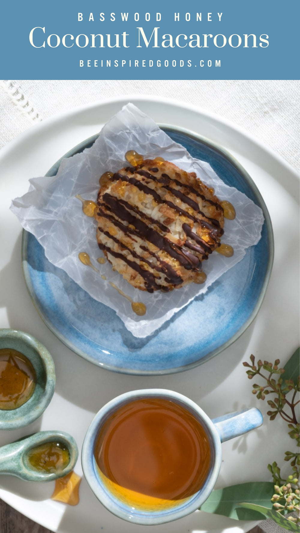 A coconut macaroon drizzled with chocolate and honey next to a cut of tea