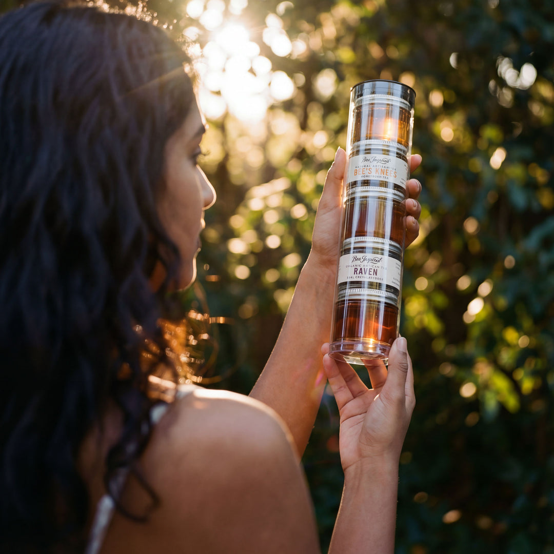 Person holding a cylindrical product with a label outdoors
