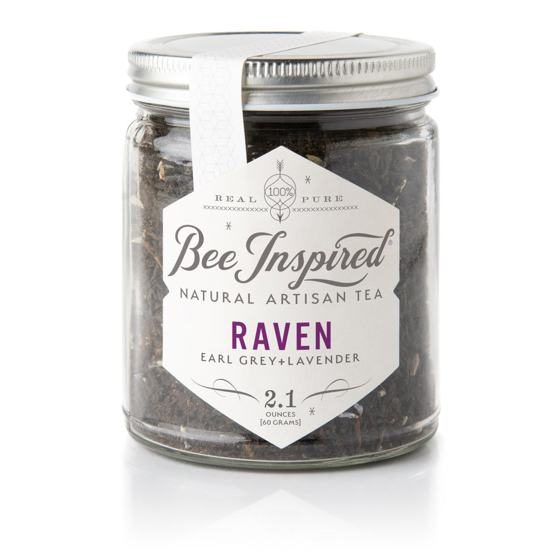 Jar of 'Bee Inspired' natural artisan tea labeled 'Raven' on a white background