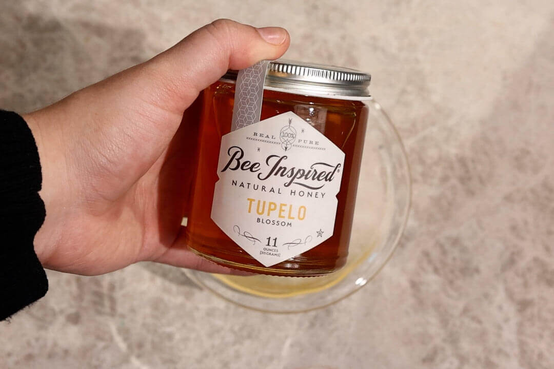 holding a jar of Tupelo honey