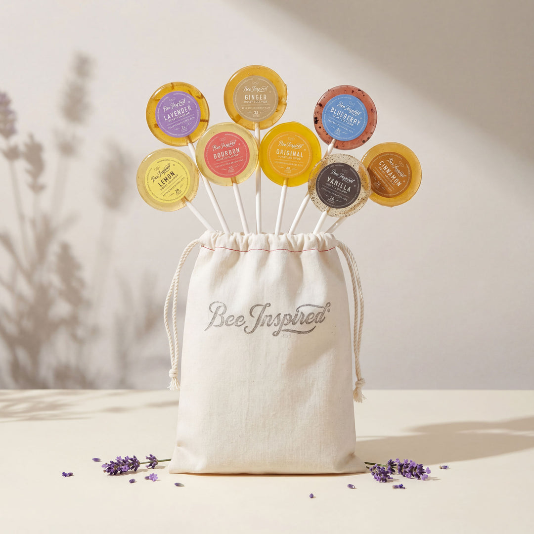 Set of colorful bee products with a 'Bee Inspired' drawstring bag on a neutral background.