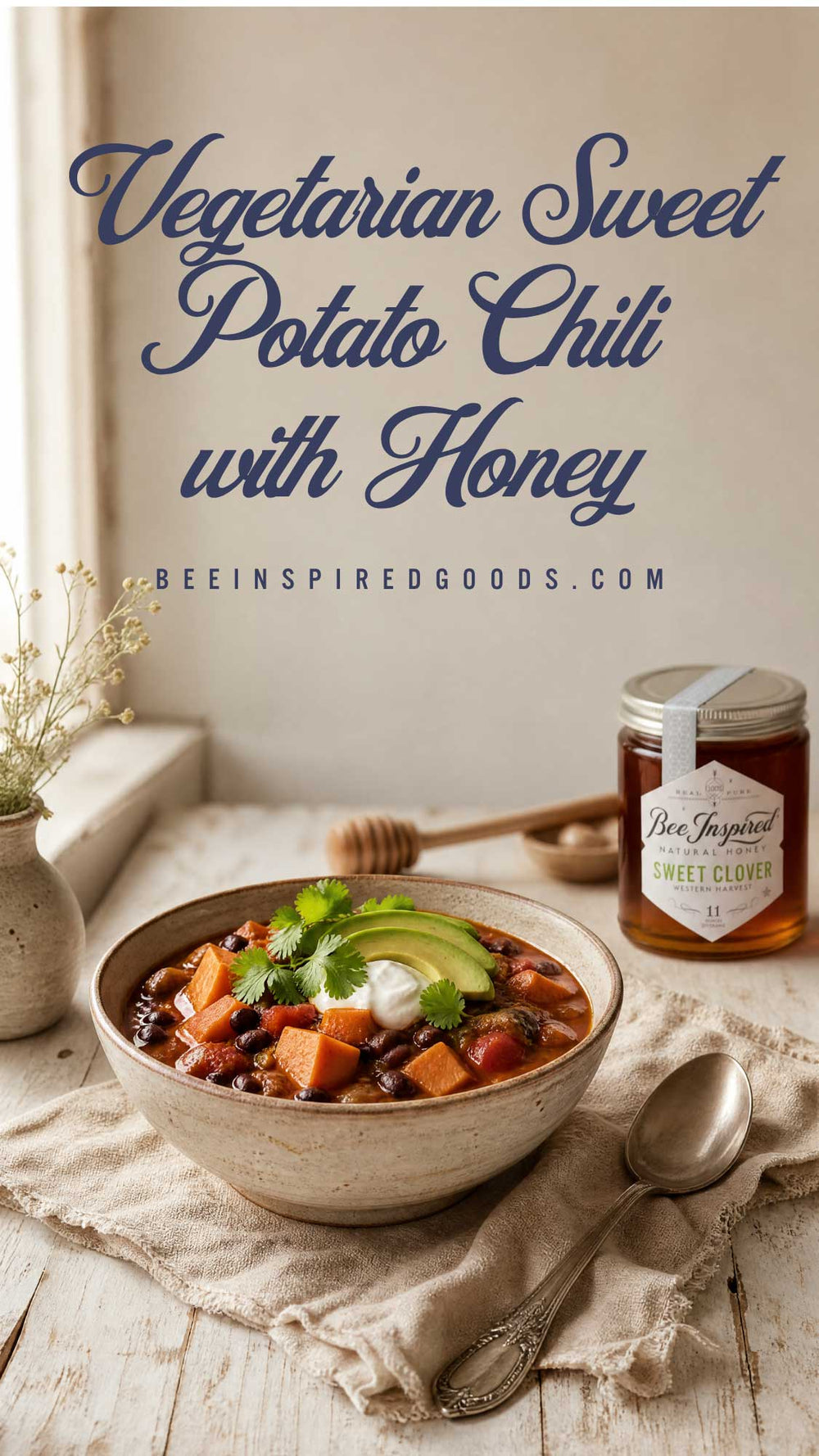 A bowl of vegetarian sweet potato chili topped with avocado, cilantro, and sour cream sits on a rustic table beside a jar of Bee Inspired Goods Sweet Clover honey, with large overlaid text reading 'Vegetarian Sweet Potato Chili with Honey' and the website BeeInspiredGoods.com.