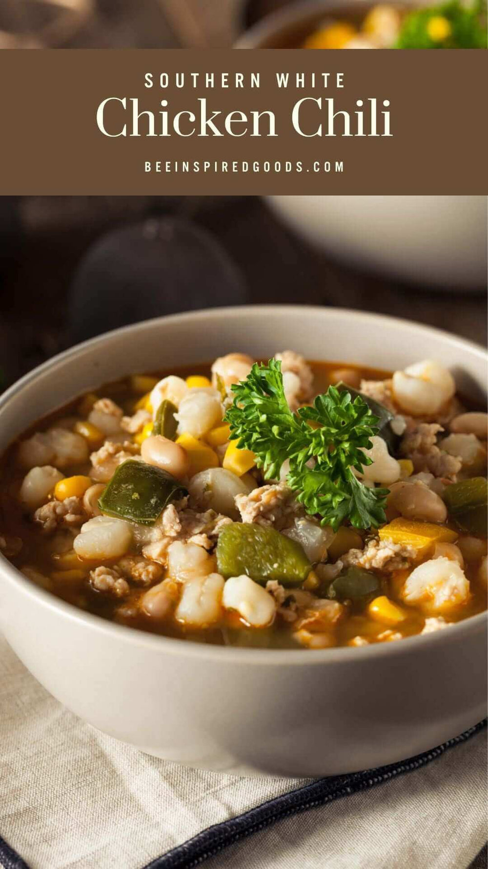 "Southern White Chicken Chili beeinspiredgoods.com" with a bowl of chili with meat, beans, and peppers 